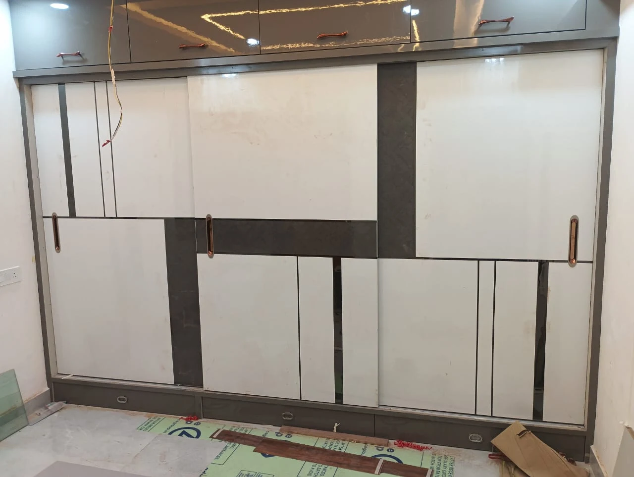 Contemporary double sliding wardrobe with geometric veneer paneling Patna