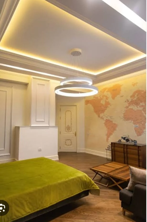 Modern ring chandelier POP false ceiling with warm ambient cove lighting by Avika Interior Patna