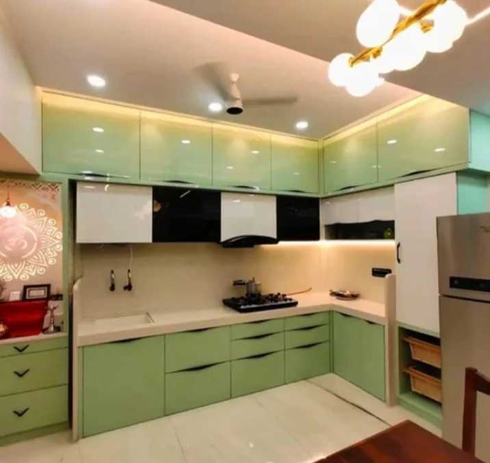 Modern sage green dual-tone modular kitchen design with quartz countertop by Avika Interior Patna