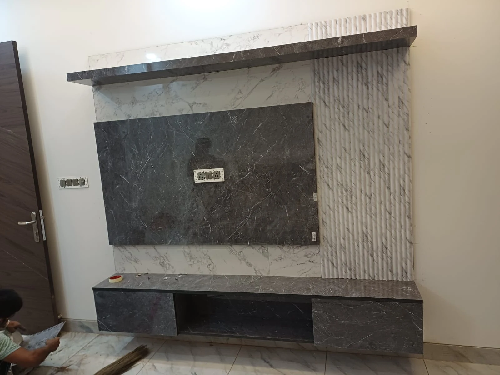 Bookmatched Italian marble floating TV entertainment unit by Avika Interior Patna