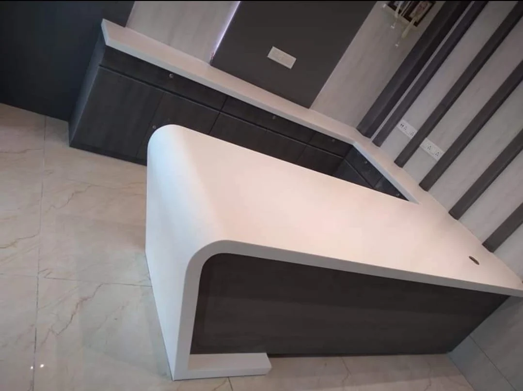 Executive waterfall desk with geometric fluted wood paneling by Avika Interior Patna
